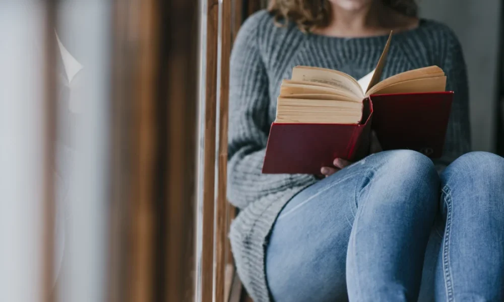 Mujer sentada leyendo pacto de ficción